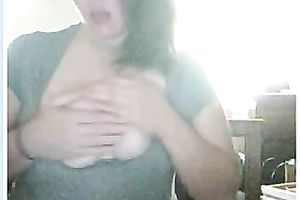 She plays with her large bumpers in front of the web web camera