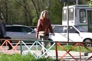 Crazy blond Irina pees her panties in the street in solo movie