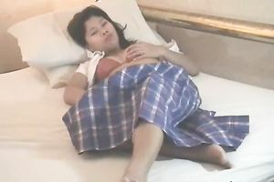Nice Asian nympho is enjoying herself in the bedroom