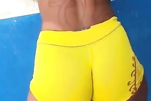 Delicious latin chick arse in yellow and taut bathing shorts
