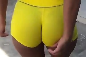 Delicious latin chick arse in yellow and taut bathing shorts