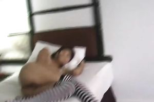 Appetizing slender legal age teenager in striped nylons plays with a marital-device