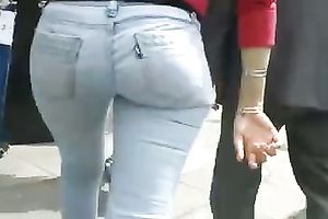 Beautiful latina playgirl in tight jeans walking down the street