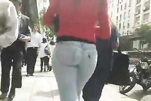 Beautiful latina playgirl in tight jeans walking down the street