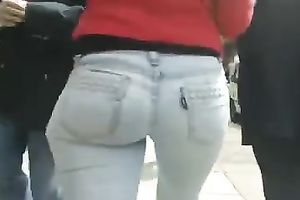 Beautiful latina playgirl in tight jeans walking down the street