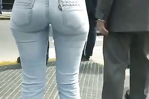 Beautiful latina playgirl in tight jeans walking down the street