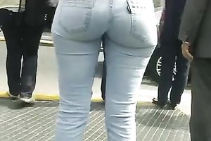 Beautiful latina playgirl in tight jeans walking down the street