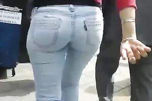 Beautiful latina playgirl in tight jeans walking down the street