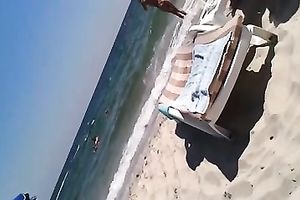 Sizzling golden-haired flashes her ideal body on a beach