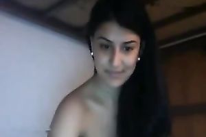 Awesome long-haired brunette hair fingers her fur pie in front of a cam