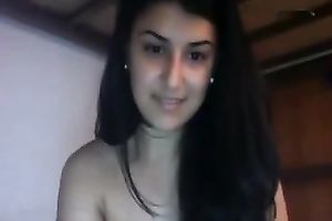 Awesome long-haired brunette hair fingers her fur pie in front of a cam