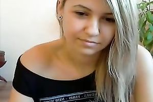 Appealing blond legal age teenager shows her natural breasts for the web camera