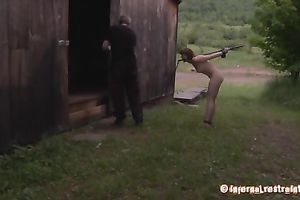 Redhead hottie bounded outdoors walks behind her master's car