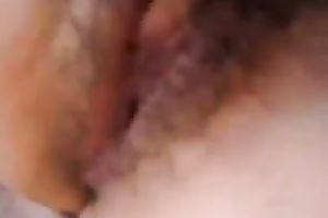 My Asian bedmate fingers her curly crotch to orgasm