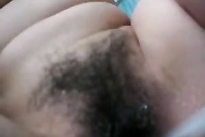 My Asian bedmate fingers her curly crotch to orgasm