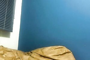 Young and large boobed dark brown undresses in front of the camera