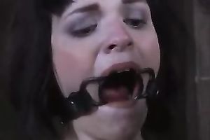 Slender brunette hair floozy with ring gag in her throat is bounded