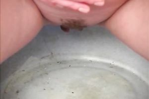 Blonde hussy undresses and pees in a bowl in the bedroom