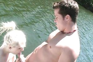 Blonde skank gives hand and enjoys rear banging outdoors