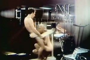 Retro skank shows her fellatio skills to a chap in a gym