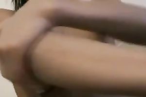 Sexy skinny legal age teenager covers her body with a lotion in the evening