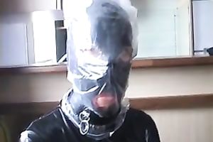 Nasty slut in latex outfit puts a plastic bag over her head