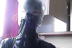 Nasty slut in latex outfit puts a plastic bag over her head