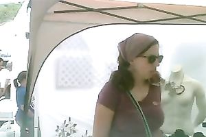 Pigtailed chick at a fair flashes her pants in hidden webcam video