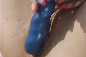 Prurient whore is having pleasure with her sex-toy outdoors