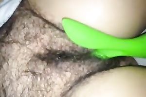 Fingering and permeating her hirsute and curly cunt with marital-device