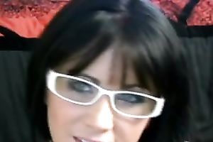 The cute and beautiful face of a college brunette hair legal age teenager in glasses