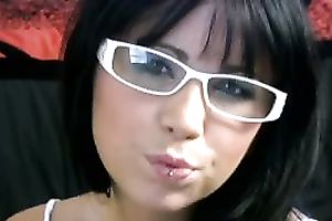 The cute and beautiful face of a college brunette hair legal age teenager in glasses