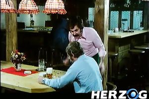 Hot retro scene with a blonde engulfing a weiner in a bar