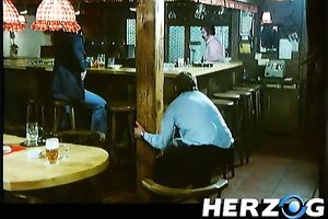 Hot retro scene with a blonde engulfing a weiner in a bar