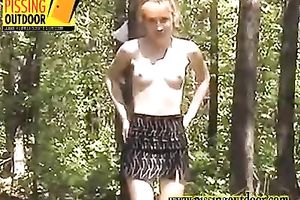 Sexy redhead honey receives undressed and pees in the forest