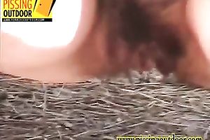 Redhead sweetie with exceedingly bushy cunt takes her pants off and pees