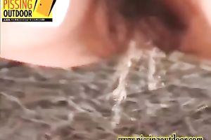 Redhead sweetie with exceedingly bushy cunt takes her pants off and pees