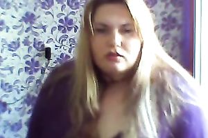 This breasty web camera model with large zeppelins licks a sweetmeat seductively