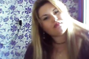 This breasty web camera model with large zeppelins licks a sweetmeat seductively