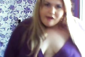 This breasty web camera model with large zeppelins licks a sweetmeat seductively