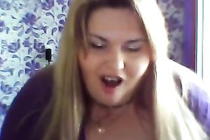 This breasty web camera model with large zeppelins licks a sweetmeat seductively