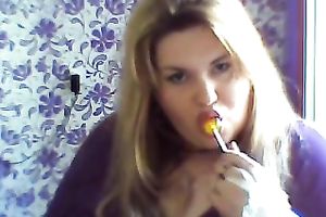 This breasty web camera model with large zeppelins licks a sweetmeat seductively
