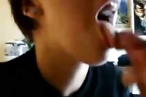 Skanky gal with tattoos shows off her pecker engulfing skills