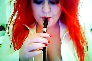 This red-haired seductress with large boobs looks so hawt whilst smokin'