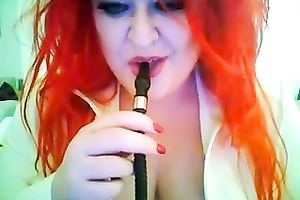 This red-haired seductress with large boobs looks so hawt whilst smokin'