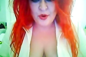 This red-haired seductress with large boobs looks so hawt whilst smokin'