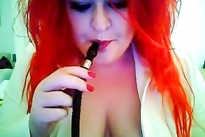 This red-haired seductress with large boobs looks so hawt whilst smokin'