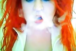 This red-haired seductress with large boobs looks so hawt whilst smokin'