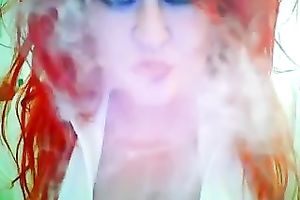 This red-haired seductress with large boobs looks so hawt whilst smokin'