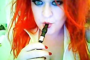 This red-haired seductress with large boobs looks so hawt whilst smokin'